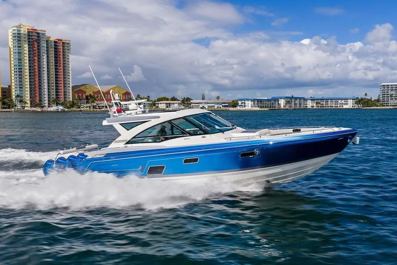 Slide: The Image of 2023 Formula 430 Super Sport Crossover cruising on water near city skyline. - 13