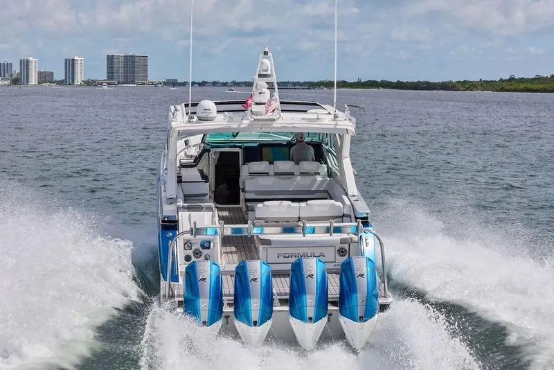 Slide: The Image of 2023 Formula 430 Super Sport Crossover cruising on water with city skyline in background. - 14