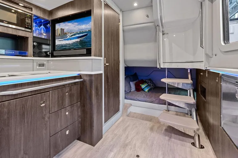 Slide: The Image of 2023 Formula 430 Super Sport Crossover interior with modern kitchen and cozy seating area. - 19
