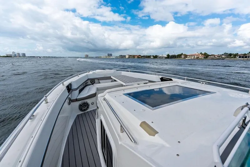 Slide: The Image of 2023 Formula 430 Super Sport Crossover cruising on open water under a partly cloudy sky. - 22