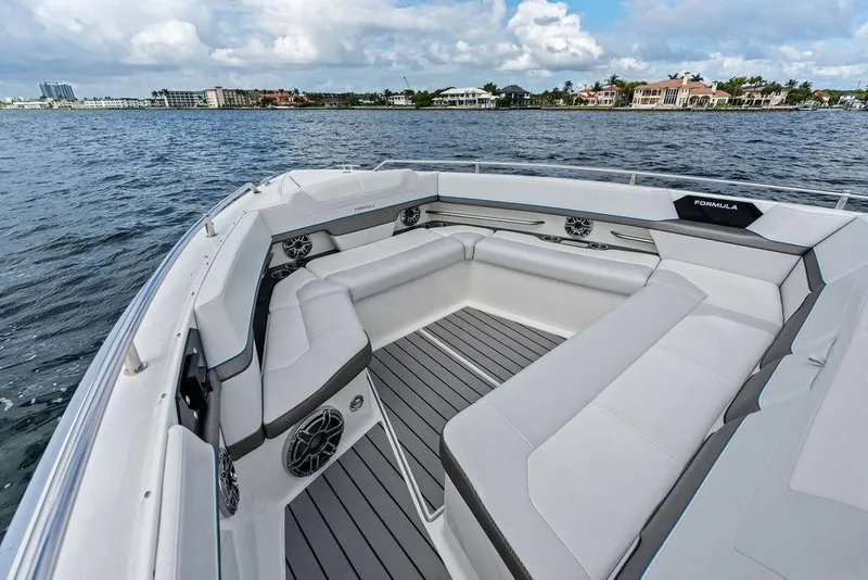 Slide: The Image of 2023 Formula 430 Super Sport Crossover boat interior with luxurious seating on open water. - 24