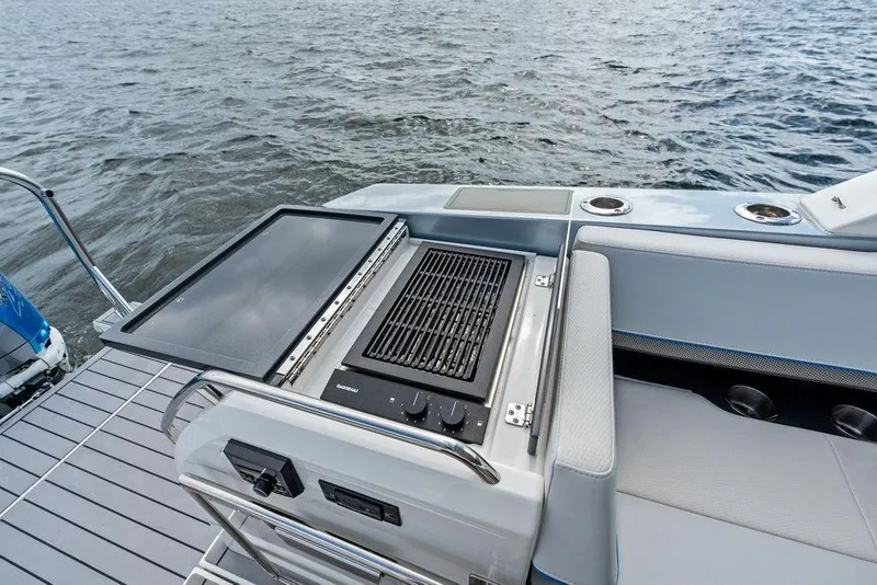 Slide: The Image of Outdoor grill on 2023 Formula 430 Super Sport Crossover boat, set against a water backdrop. - 28