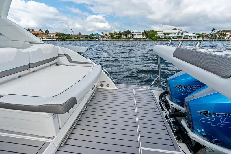 Slide: The Image of 2023 Formula 430 Super Sport Crossover boat with luxurious seating and powerful engines on a scenic waterway. - 29