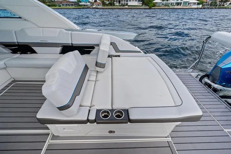 Slide: The Image of 2023 Formula 430 Super Sport Crossover boat with luxurious seating and cup holders. - 34