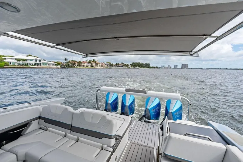 Slide: The Image of 2023 Formula 430 Super Sport Crossover cruising on a scenic waterfront. - 37