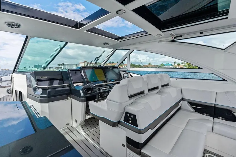 Slide: The Image of Interior of 2023 Formula 430 Super Sport Crossover yacht with luxurious seating and modern dashboard. - 48
