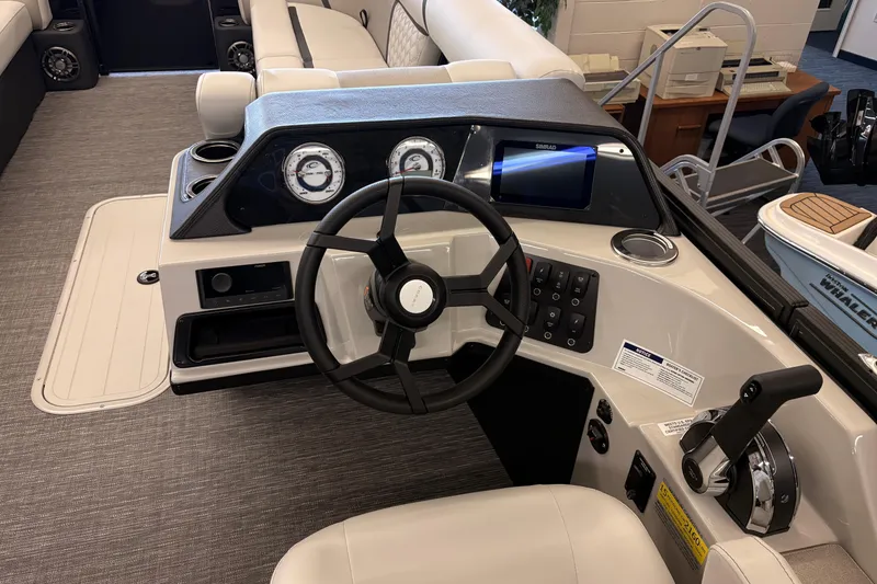 Slide: The Image of Helm of 2026 Crest Conquest 250 SLSC boat with steering wheel and control panel. - 10