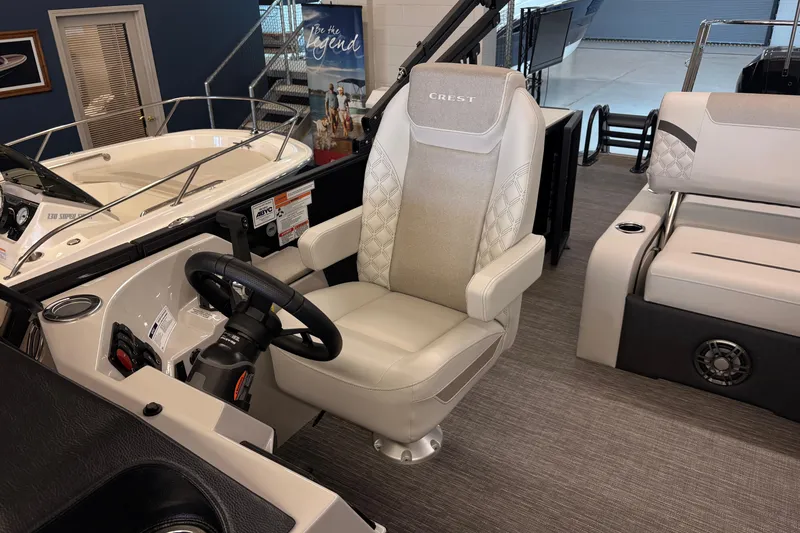 Slide: The Image of Captain's chair in 2026 Crest Conquest 250 SLSC boat interior, showcasing luxury design. - 12