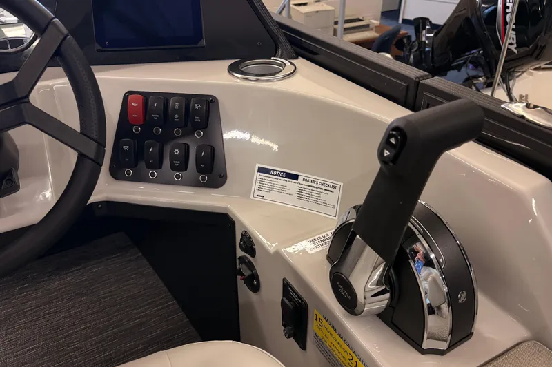 Slide: The Image of Control panel of 2026 Crest Conquest 250 SLSC boat with steering wheel and throttle lever. - 13