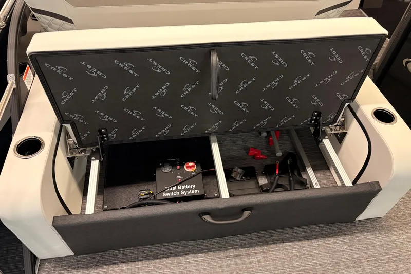 Slide: The Image of 2026 Crest Conquest 250 SLSC boat seat storage with dual battery switch system. - 18