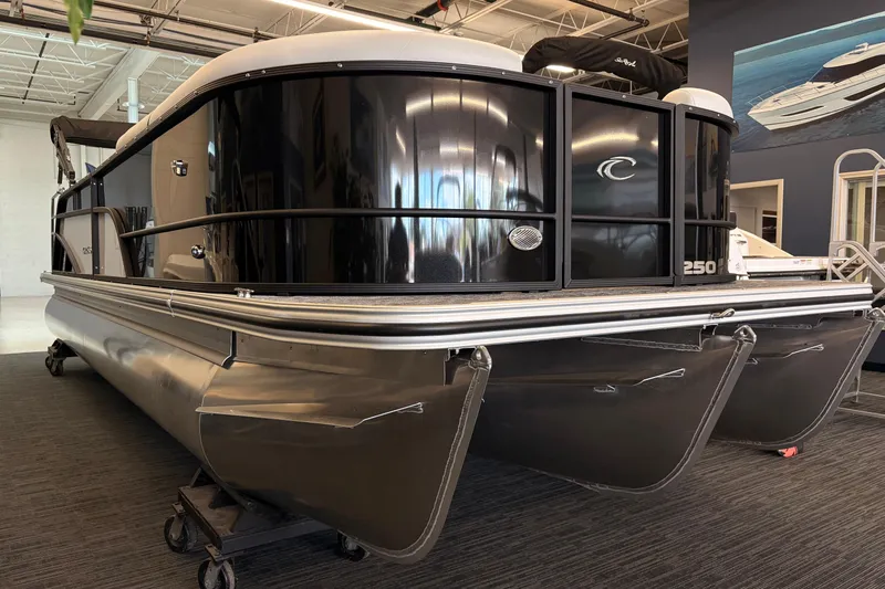Slide: The Image of 2026 Crest Conquest 250 SLSC pontoon boat displayed in showroom. - 2