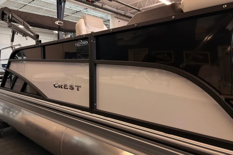 Slide: The Image of 2026 Crest Conquest 250 SLSC pontoon boat, sleek design, showroom display. - 4
