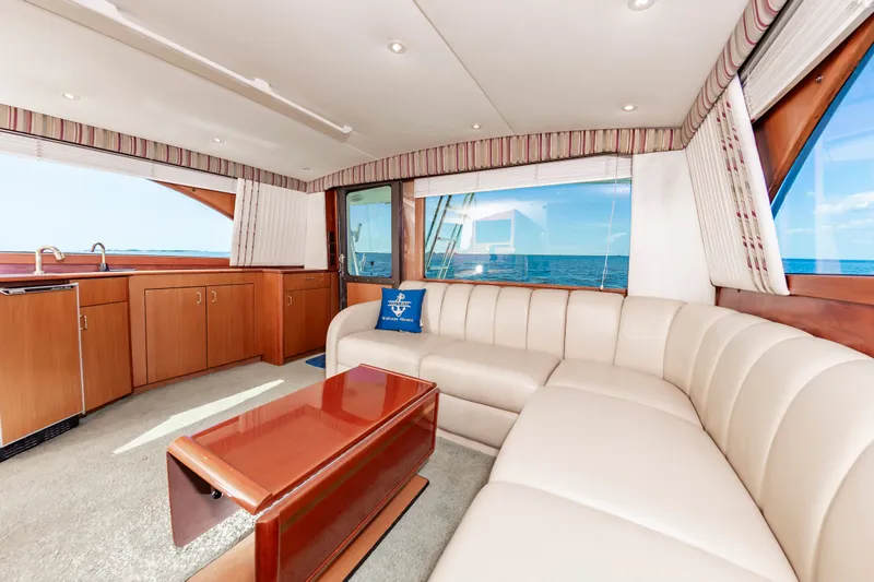 Slide: The Image of Interior of 2000 Ocean 48 SuperSport yacht with luxurious sofa and ocean view. - 28