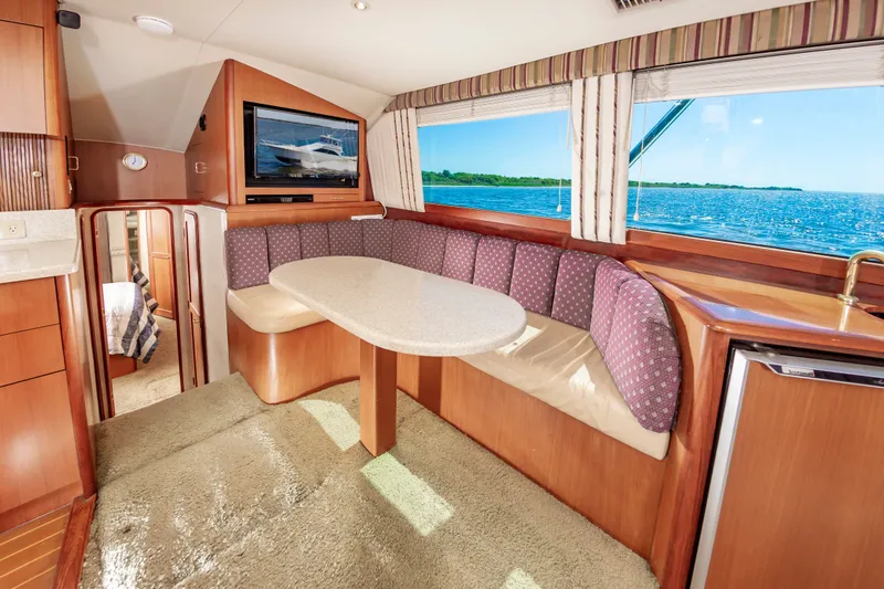 Slide: The Image of Interior of 2000 Ocean 48 SuperSport yacht with dining area and ocean view. - 29