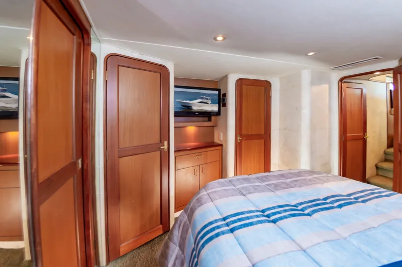Slide: The Image of Interior of 2000 Ocean 48 SuperSport yacht with wooden doors and bed. - 34