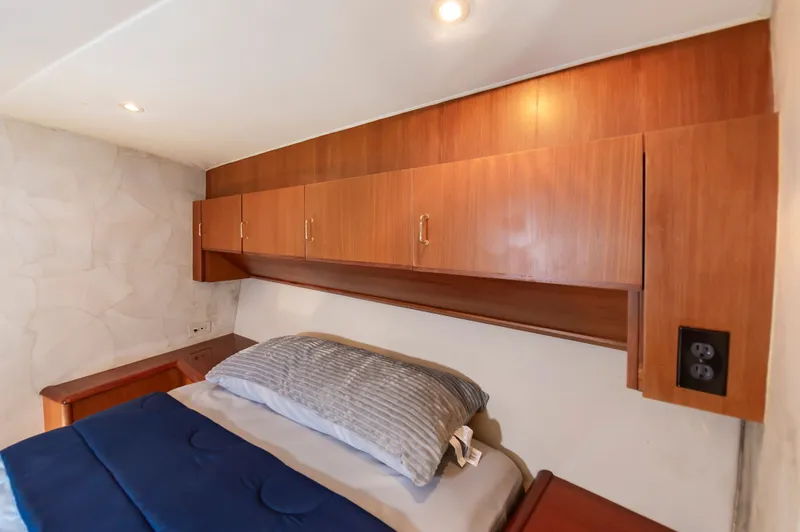 Slide: The Image of Interior of 2000 Ocean 48 SuperSport yacht with wooden cabinets and bed. - 36