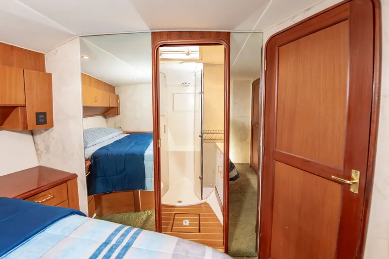 Slide: The Image of Interior of 2000 Ocean 48 SuperSport yacht featuring bedroom and bathroom. - 37