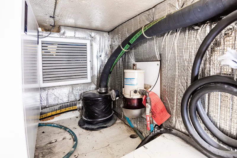 Slide: The Image of Engine room of Ocean 48 SuperSport 2000 with hoses and filters. - 46