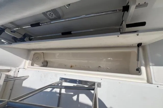 Slide: The Image of 2004 Boston Whaler 270 Outrage storage compartment with stainless steel railing. - 10