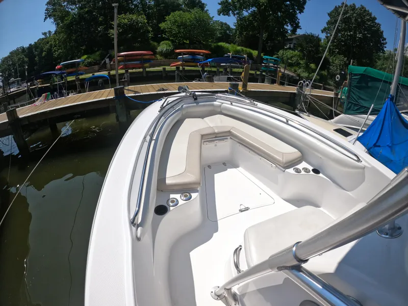 Slide: The Image of 2004 Boston Whaler 270 Outrage boat docked, featuring spacious seating and sleek design. - 2