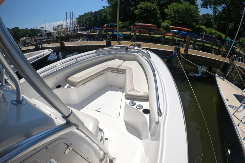 Slide: The Image of 2004 Boston Whaler 270 Outrage boat docked, featuring spacious seating and sleek design. - 3