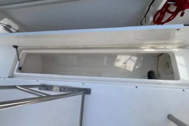 Slide: The Image of Open storage compartment on a 2004 Boston Whaler 270 Outrage boat. - 9