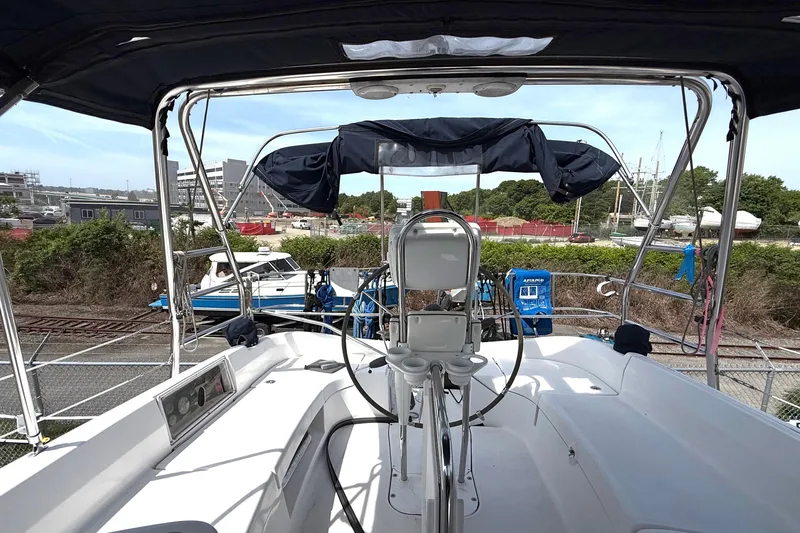 Slide: The Image of 2005 Hunter 41 Deck Salon yacht cockpit with steering wheel and marina view. - 11