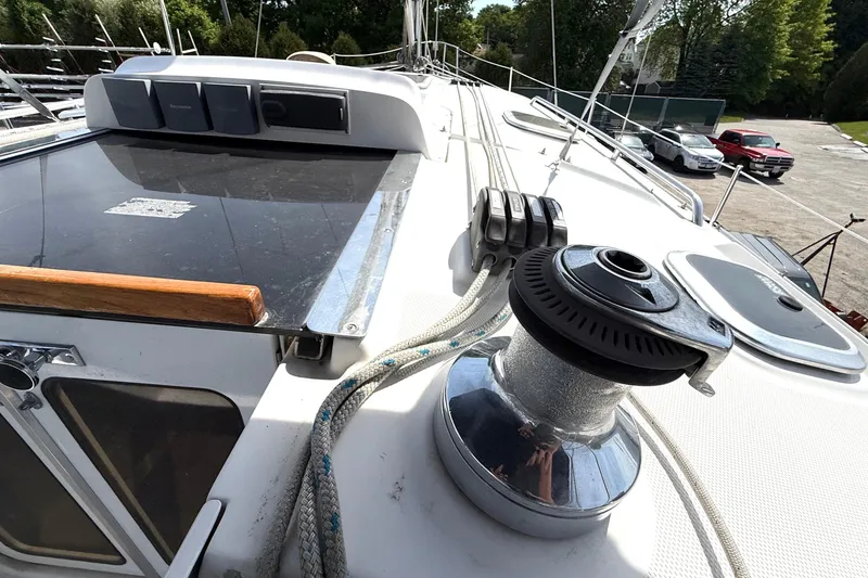 Slide: The Image of 2005 Hunter 41 Deck Salon sailboat deck with winch and ropes in marina. - 13