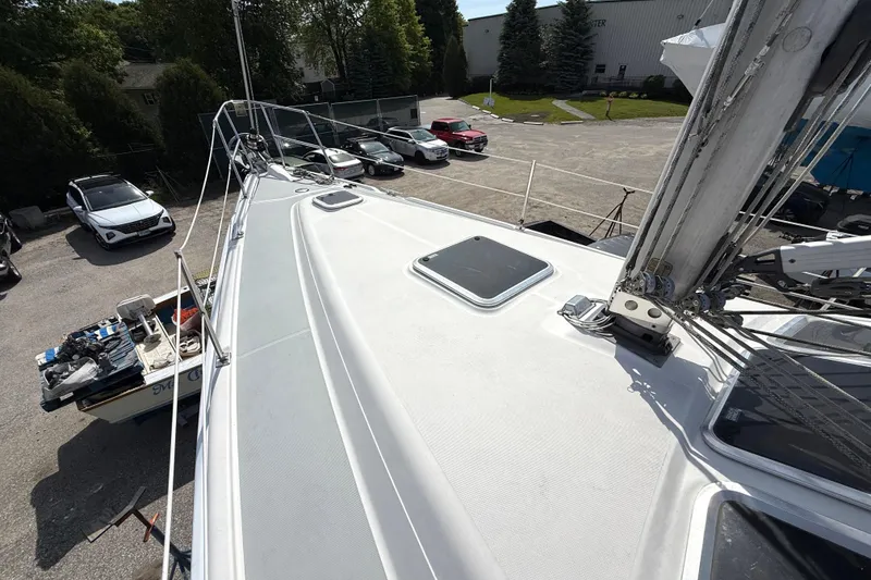 Slide: The Image of 2005 Hunter 41 Deck Salon sailboat on land, surrounded by parked cars. - 21