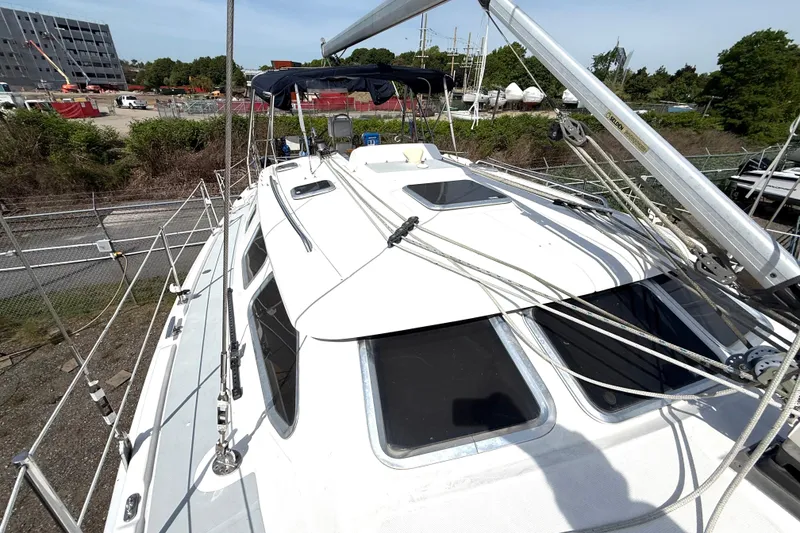 Slide: The Image of 2005 Hunter 41 Deck Salon sailboat on land, surrounded by construction and greenery. - 25