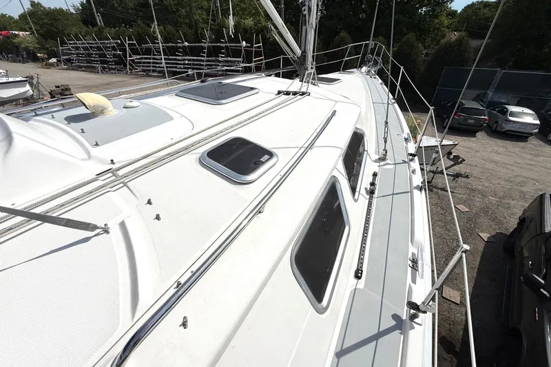 Slide: The Image of 2005 Hunter 41 Deck Salon sailboat, docked, showcasing sleek deck design and rigging. - 26