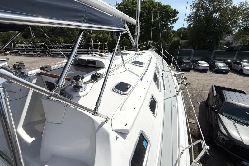 Slide: The Image of 2005 Hunter 41 Deck Salon sailboat with sleek design, docked in a marina. - 27