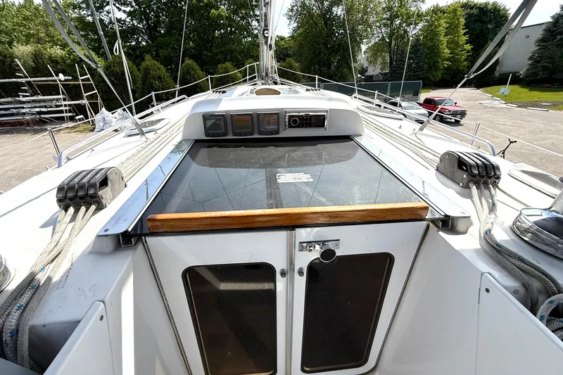 Slide: The Image of 2005 Hunter 41 Deck Salon sailboat cockpit with ropes and control panels. - 28