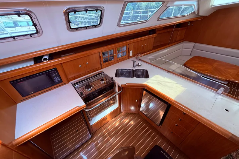 Slide: The Image of Luxurious interior of 2005 Hunter 41 Deck Salon yacht with modern kitchen and seating area. - 32