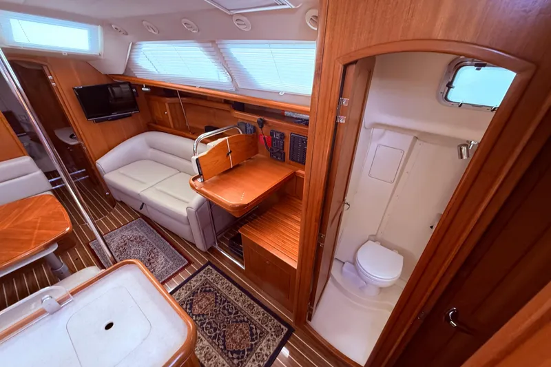 Slide: The Image of Interior of 2005 Hunter 41 Deck Salon yacht, featuring cozy seating and compact bathroom. - 35