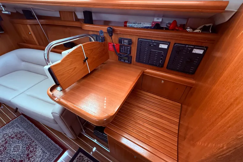 Slide: The Image of Interior of 2005 Hunter 41 Deck Salon with navigation station and control panels. - 36