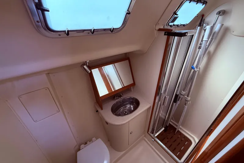 Slide: The Image of Bathroom interior of 2005 Hunter 41 Deck Salon yacht, featuring sink, mirror, and shower. - 39