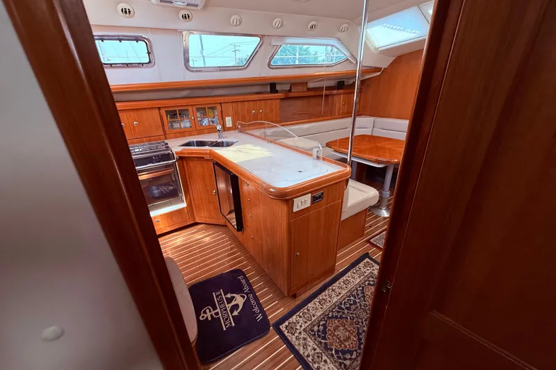 Slide: The Image of Interior of 2005 Hunter 41 Deck Salon yacht with kitchen and dining area. - 41