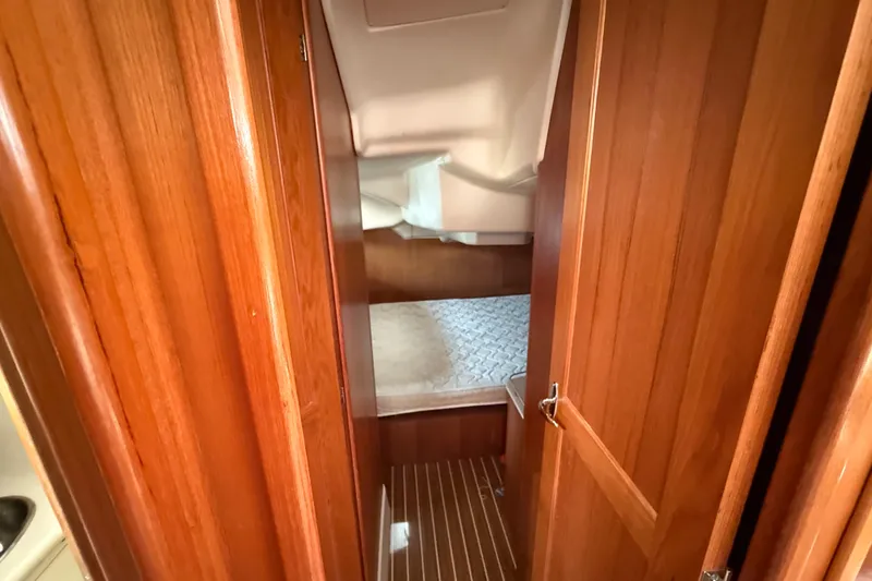 Slide: The Image of Interior cabin of 2005 Hunter 41 Deck Salon with wooden finish and cozy bed. - 44