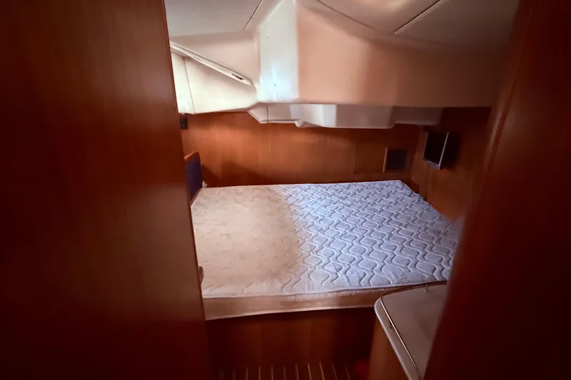 Slide: The Image of Interior cabin of 2005 Hunter 41 Deck Salon with bed and wooden paneling. - 45