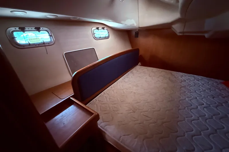 Slide: The Image of Interior cabin of 2005 Hunter 41 Deck Salon yacht with bed and portholes. - 46