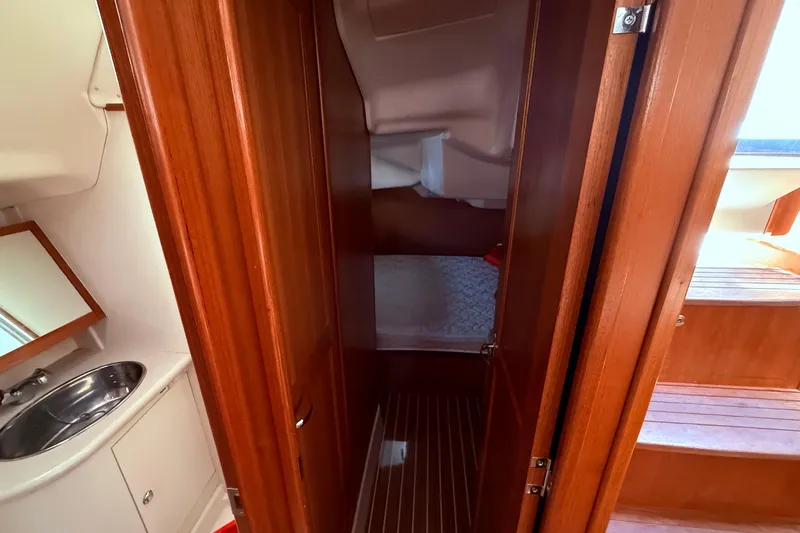 Slide: The Image of Interior of 2005 Hunter 41 Deck Salon with wooden cabinetry and compact sink. - 47