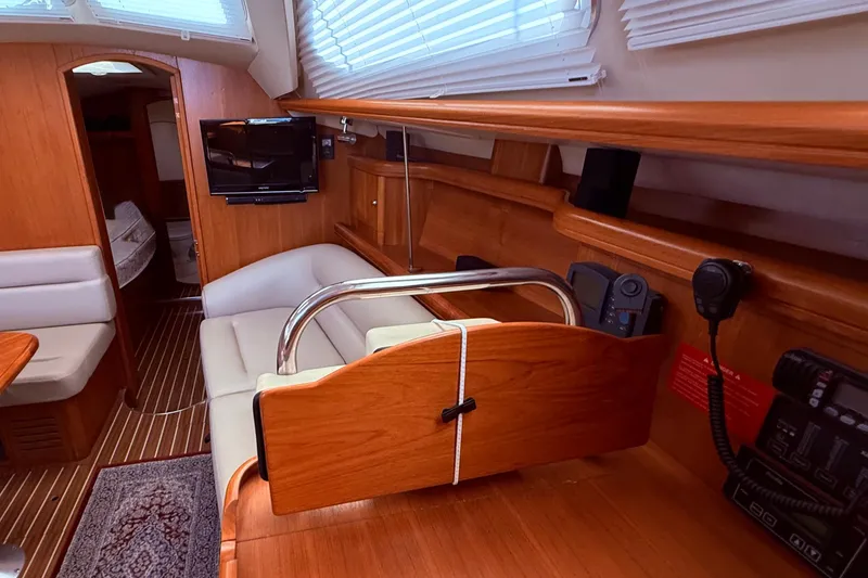 Slide: The Image of Interior of 2005 Hunter 41 Deck Salon yacht with wood finish and seating area. - 52