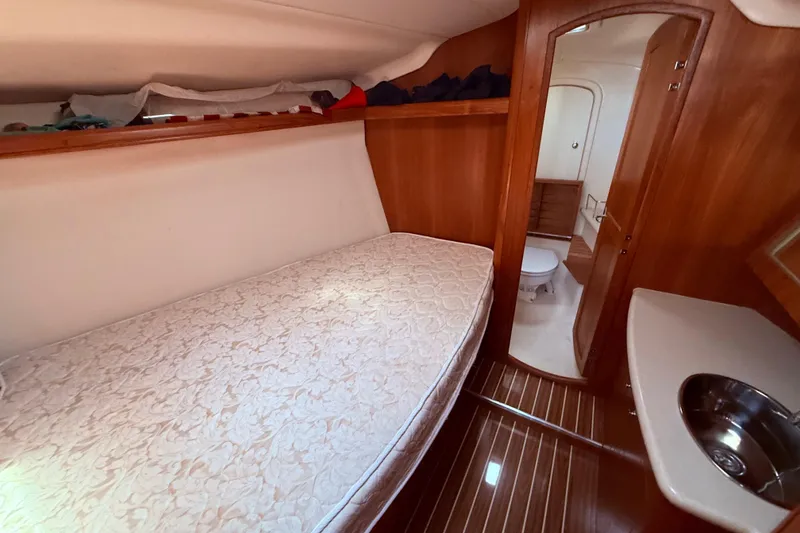 Slide: The Image of 2005 Hunter 41 Deck Salon interior with bed, sink, and bathroom. - 55