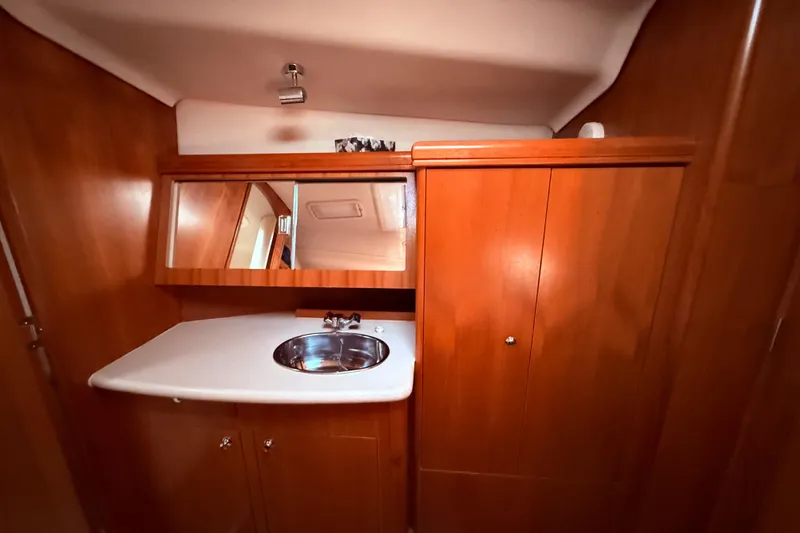 Slide: The Image of 2005 Hunter 41 Deck Salon interior with wooden cabinetry and sink. - 56