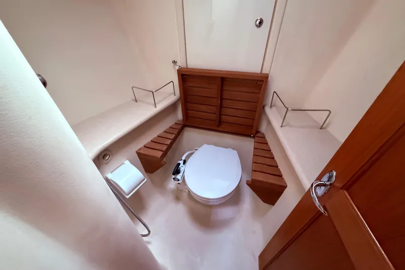 Slide: The Image of Bathroom interior of 2005 Hunter 41 Deck Salon yacht, featuring wooden accents and compact design. - 58