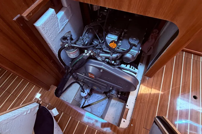 Slide: The Image of Engine compartment of a 2005 Hunter 41 Deck Salon sailboat, featuring a Yanmar engine. - 61