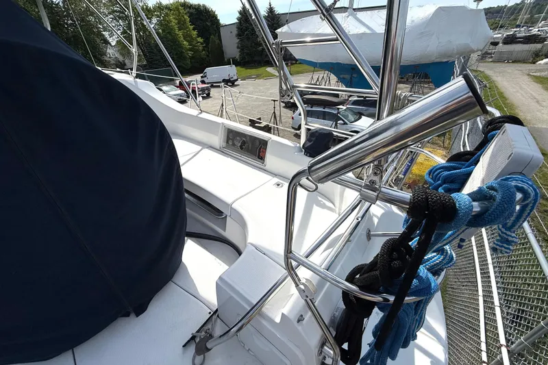 Slide: The Image of 2005 Hunter 41 Deck Salon sailboat deck with ropes and stainless steel fittings. - 8