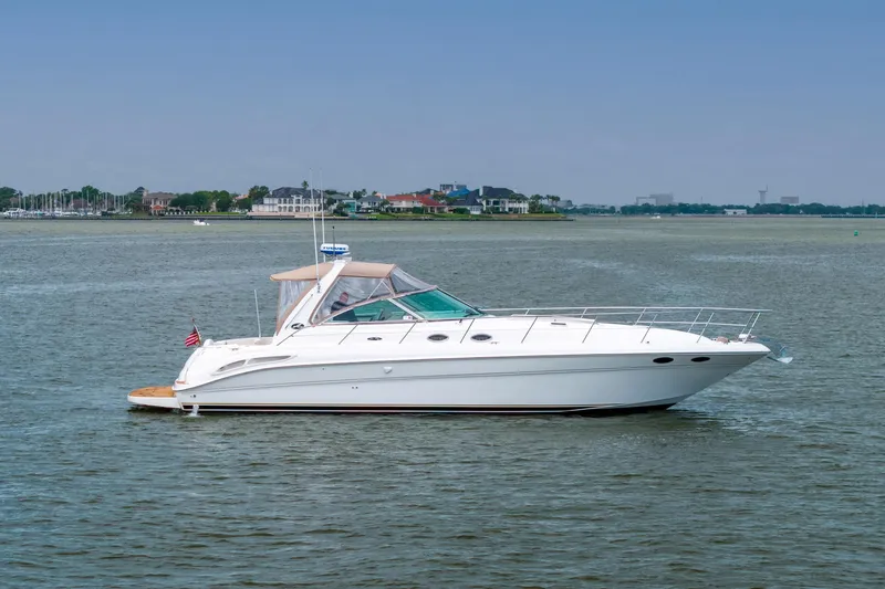 The Image of 2002 Sea Ray 410 Express Cruiser on calm waters, showcasing sleek design and luxury features. - 0