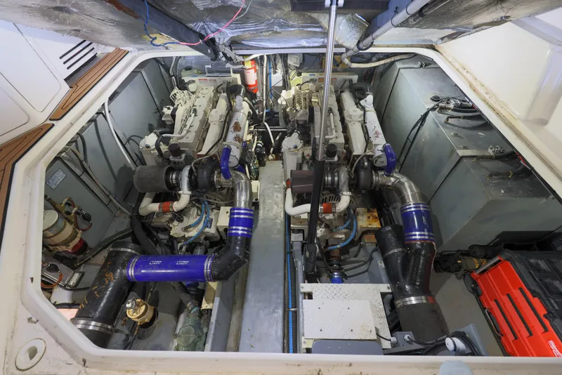 Slide: The Image of Engine room of a 2002 Sea Ray 410 Express Cruiser, showcasing dual engines and mechanical components. - 29